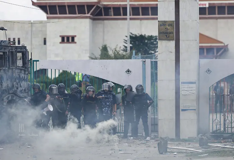 A-riot-police-officer-aims-his-rifle-while-guarding-the-Parliament-during-youth-led-protests-that-toppled-Nepal-s-prime-minister-in-Kathmandu-Nepal-September-8-2025-77-people-were-killed-in-two-days-of-protests-that-later-forced-the-resignation-of-then-Prime-Minister-K-P-Sharma-Oli-and-shook-up-Nepal-s-broken-political-system-A-state-appointed-commission-charged-with-conducting-an-investigation-into-the-protests-including-the-use-of-live-ammunition-against-young-demonstrators-has-received-three-extensions-to-complete-the-probe-Its-final-findings-are-expected-to-be-released-after-the-general-election-set-for-March-5-2026-REUTERS-Navesh-Chitrakar-SEARCH-CHITRAKAR-NEPAL-PROTESTER-FAMILIES-FOR-THIS-STORY-SEARCH-WIDER-IMAGE-FOR-ALL-STORIES