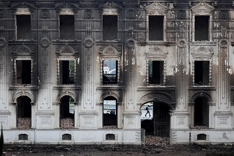 A-person-walks-past-the-burned-Singha-Durbar-office-complex-which-houses-Nepal-s-prime-minister-s-office-and-other-ministries-after-youth-led-protests-that-toppled-the-prime-minister-in-Kathmandu-Nepal-September-11-2025-77-people-were-killed-in-two-days-of-protests-that-later-forced-the-resignation-of-then-Prime-Minister-K-P-Sharma-Oli-and-shook-up-Nepal-s-broken-political-system-A-state-appointed-commission-charged-with-conducting-an-investigation-into-the-protests-including-the-use-of-live-ammunition-against-young-demonstrators-has-received-three-extensions-to-complete-the-probe-Its-final-findings-are-expected-to-be-released-after-the-general-election-set-for-March-5-2026-REUTERS-Navesh-Chitrakar-SEARCH-CHITRAKAR-NEPAL-PROTESTER-FAMILIES-FOR-THIS-STORY-SEARCH-WIDER-IMAGE-FOR-ALL-STORIES