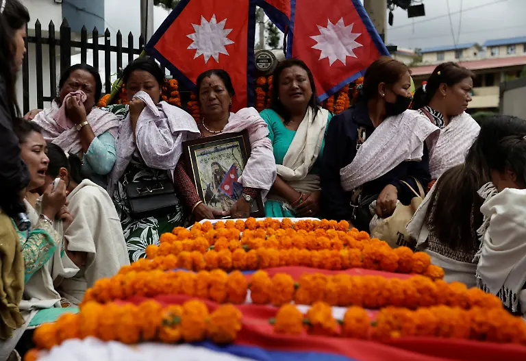 Family-members-including-Bina-Awale-sister-of-Binod-Maharjan-34-who-was-shot-dead-during-youth-led-protests-that-toppled-Nepal-s-prime-minister-mourn-next-to-the-coffin-containing-his-body-as-they-take-part-in-a-tribute-rally-in-Kathmandu-Nepal-September-16-2025-After-feeding-pigeons-on-the-terrace-like-he-did-most-mornings-Binod-abruptly-left-home-on-September-8-leaving-his-breakfast-of-rice-and-lentils-The-family-only-discovered-he-had-joined-the-swelling-protests-after-Binod-s-elder-brother-received-a-phone-call-from-one-of-his-sibling-s-childhood-friends-and-rushed-to-Kathmandu-s-Everest-Hospital-REUTERS-Navesh-Chitrakar-SEARCH-CHITRAKAR-NEPAL-PROTESTER-FAMILIES-FOR-THIS-STORY-SEARCH-WIDER-IMAGE-FOR-ALL-STORIES