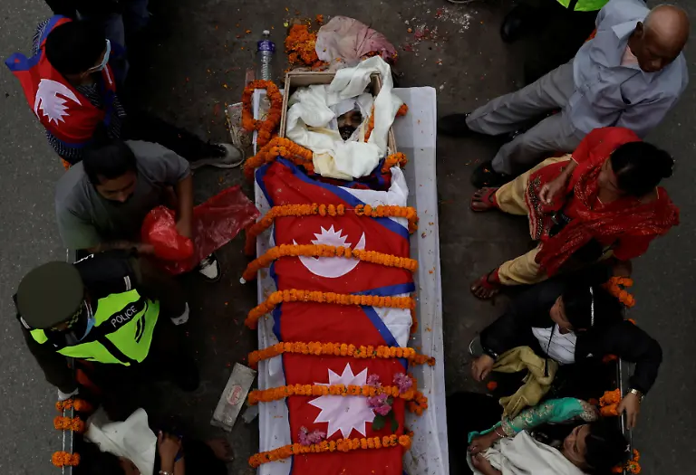 SENSITIVE-MATERIAL-THIS-IMAGE-MAY-OFFEND-OR-DISTURB-The-body-of-Binod-Maharjan-34-who-was-shot-dead-during-youth-led-protests-that-toppled-Nepal-s-prime-minister-is-taken-to-the-Pashupatinath-temple-for-cremation-during-a-tribute-rally-in-Kathmandu-Nepal-September-16-2025-After-feeding-pigeons-on-the-terrace-like-he-did-most-mornings-Binod-abruptly-left-home-on-September-8-leaving-his-breakfast-of-rice-and-lentils-The-family-only-discovered-he-had-joined-the-swelling-protests-after-Binod-s-elder-brother-received-a-phone-call-from-one-of-his-sibling-s-childhood-friends-and-rushed-to-Kathmandu-s-Everest-Hospital-My-son-said-he-would-return-home-and-eat-the-meal-he-had-left-behind-said-his-mother-Lata-Maya-Maharjan-75-He-never-came-back-REUTERS-Navesh-Chitrakar-SEARCH-CHITRAKAR-NEPAL-PROTESTER-FAMILIES-FOR-THIS-STORY-SEARCH-WIDER-IMAGE-FOR-ALL-STORIES