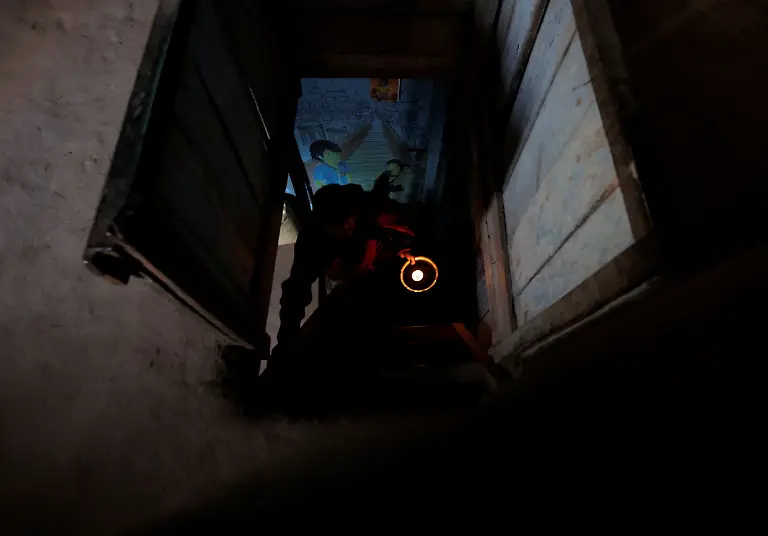 Lata-Maya-Maharjan-75-mother-of-Binod-Maharjan-34-who-was-shot-dead-during-youth-led-protests-that-toppled-Nepal-s-prime-minister-and-prompted-elections-set-for-March-5-2026-holds-a-lit-oil-lamp-as-she-climbs-the-stairs-next-to-paintings-made-by-Binod-that-cover-the-wall-of-her-house-in-Lalitpur-Nepal-February-21-2026-After-feeding-pigeons-on-the-terrace-like-he-did-most-mornings-Binod-abruptly-left-home-on-September-8-leaving-his-breakfast-of-rice-and-lentils-The-family-only-discovered-he-had-joined-the-swelling-protests-after-Binod-s-elder-brother-received-a-phone-call-from-one-of-his-sibling-s-childhood-friends-and-rushed-to-Kathmandu-s-Everest-Hospital-My-son-said-he-would-return-home-and-eat-the-meal-he-had-left-behind-said-Lata-Maya-He-never-came-back-REUTERS-Navesh-Chitrakar-SEARCH-CHITRAKAR-NEPAL-PROTESTER-FAMILIES-FOR-THIS-STORY-SEARCH-WIDER-IMAGE-FOR-ALL-STORIES