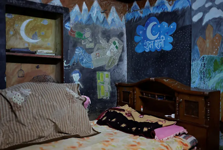 A-self-portrait-depicting-Binod-Maharjan-34-who-was-shot-dead-during-youth-led-protests-that-toppled-Nepal-s-prime-minister-and-prompted-elections-set-for-March-5-2026-painted-by-him-shows-him-with-his-signature-long-dreadlocks-and-a-cigarette-and-surrounded-by-his-nieces-and-nephews-inside-his-mother-s-room-in-Lalitpur-Nepal-February-20-2026-After-feeding-pigeons-on-the-terrace-like-he-did-most-mornings-Binod-abruptly-left-home-on-September-8-leaving-his-breakfast-of-rice-and-lentils-The-family-only-discovered-he-had-joined-the-swelling-protests-after-Binod-s-elder-brother-received-a-phone-call-from-one-of-his-sibling-s-childhood-friends-and-rushed-to-Kathmandu-s-Everest-Hospital-My-son-said-he-would-return-home-and-eat-the-meal-he-had-left-behind-said-Lata-Maya-He-never-came-back-REUTERS-Navesh-Chitrakar-SEARCH-CHITRAKAR-NEPAL-PROTESTER-FAMILIES-FOR-THIS-STORY-SEARCH-WIDER-IMAGE-FOR-ALL-STORIES