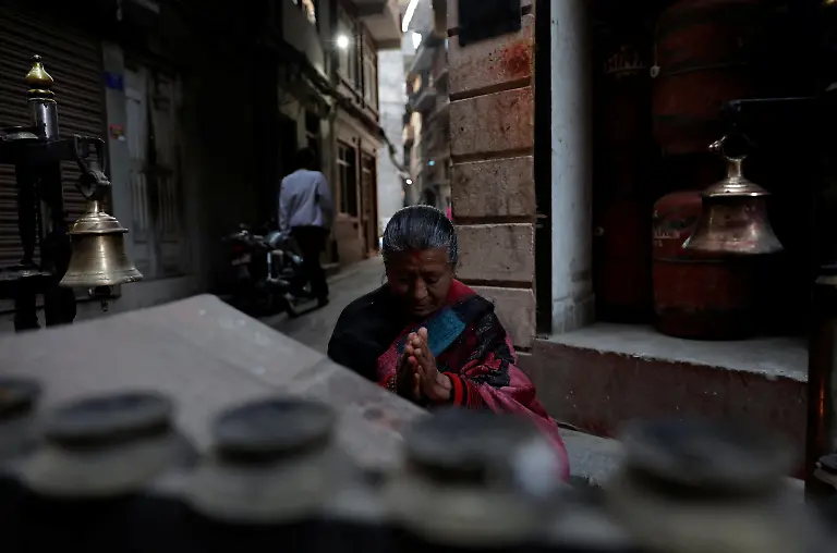 Lata-Maya-Maharjan-75-mother-of-Binod-Maharjan-34-who-was-shot-dead-during-youth-led-protests-that-toppled-Nepal-s-prime-minister-and-prompted-elections-set-for-March-5-2026-offers-prayers-at-a-temple-near-her-home-in-Lalitpur-Nepal-February-21-2026-After-feeding-pigeons-on-the-terrace-like-he-did-most-mornings-Binod-abruptly-left-home-on-September-8-leaving-his-breakfast-of-rice-and-lentils-The-family-only-discovered-he-had-joined-the-swelling-protests-after-Binod-s-elder-brother-received-a-phone-call-from-one-of-his-sibling-s-childhood-friends-and-rushed-to-Kathmandu-s-Everest-Hospital-My-son-said-he-would-return-home-and-eat-the-meal-he-had-left-behind-said-Lata-Maya-He-never-came-back-REUTERS-Navesh-Chitrakar-SEARCH-CHITRAKAR-NEPAL-PROTESTER-FAMILIES-FOR-THIS-STORY-SEARCH-WIDER-IMAGE-FOR-ALL-STORIES