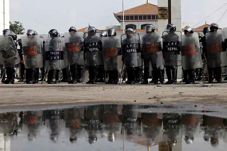 Members-of-Nepal-s-Armed-Police-Force-APF-stand-guard-outside-the-Parliament-building-during-a-curfew-imposed-after-youth-led-protests-that-toppled-Nepal-s-prime-minister-in-Kathmandu-Nepal-September-9-2025-77-people-were-killed-in-two-days-of-protests-that-later-forced-the-resignation-of-then-Prime-Minister-K-P-Sharma-Oli-and-shook-up-Nepal-s-broken-political-system-A-state-appointed-commission-charged-with-conducting-an-investigation-into-the-protests-including-the-use-of-live-ammunition-against-young-demonstrators-has-received-three-extensions-to-complete-the-probe-Its-final-findings-are-expected-to-be-released-after-the-general-election-set-for-March-5-2026-REUTERS-Navesh-Chitrakar-SEARCH-CHITRAKAR-NEPAL-PROTESTER-FAMILIES-FOR-THIS-STORY-SEARCH-WIDER-IMAGE-FOR-ALL-STORIES