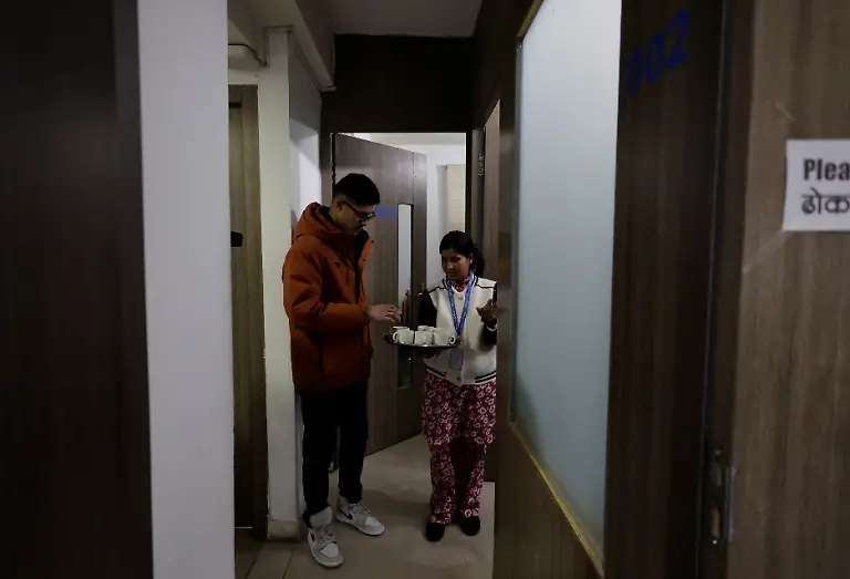 Parbati-Subedi-28-wife-of-Dev-Kumar-Subedi-29-who-was-shot-dead-during-youth-led-protests-that-toppled-Nepal-s-prime-minister-and-prompted-elections-set-for-March-5-2026-serves-tea-to-an-employee-of-Chaudhary-Group-one-of-Nepal-s-largest-corporations-where-she-was-offered-a-job-as-an-office-housekeeper-after-her-husband-died-in-Lalitpur-Nepal-February-22-2026-Subedi-has-received-the-1-5-million-rupees-compensation-that-an-interim-government-has-provided-to-the-families-of-42-of-the-77-killed-that-it-declared-martyrs-I-believe-this-protest-happened-because-people-wanted-change-in-Nepal-and-change-in-our-leaders-Subedi-said-Those-in-power-forgot-about-families-like-ours-for-whom-putting-two-meals-on-the-table-is-a-daily-struggle-REUTERS-Navesh-Chitrakar-SEARCH-CHITRAKAR-NEPAL-PROTESTER-FAMILIES-FOR-THIS-STORY-SEARCH-WIDER-IMAGE-FOR-ALL-STORIES