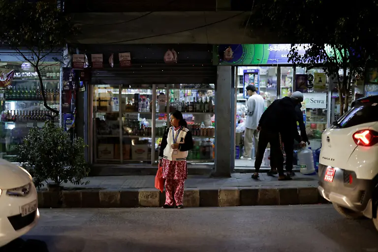 Parbati-Subedi-28-wife-of-Dev-Kumar-Subedi-29-who-was-shot-dead-during-youth-led-protests-that-toppled-Nepal-s-prime-minister-and-prompted-elections-set-for-March-5-2026-crosses-a-street-as-she-heads-home-after-work-in-Lalitpur-Nepal-February-22-2026-Subedi-has-received-the-1-5-million-rupees-compensation-that-an-interim-government-has-provided-to-the-families-of-42-of-the-77-killed-that-it-declared-martyrs-I-believe-this-protest-happened-because-people-wanted-change-in-Nepal-and-change-in-our-leaders-Subedi-said-Those-in-power-forgot-about-families-like-ours-for-whom-putting-two-meals-on-the-table-is-a-daily-struggle-REUTERS-Navesh-Chitrakar-SEARCH-CHITRAKAR-NEPAL-PROTESTER-FAMILIES-FOR-THIS-STORY-SEARCH-WIDER-IMAGE-FOR-ALL-STORIES