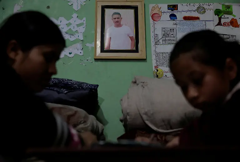 Parbati-Subedi-28-wife-of-Dev-Kumar-Subedi-29-who-was-shot-dead-during-youth-led-protests-that-toppled-Nepal-s-prime-minister-and-prompted-elections-set-for-March-5-2026-helps-her-daughter-Saloni-Subedi-with-her-homework-as-they-sit-next-to-a-portrait-of-Dev-in-Lalitpur-Nepal-February-22-2026-Subedi-has-received-the-1-5-million-rupees-compensation-that-an-interim-government-has-provided-to-the-families-of-42-of-the-77-killed-that-it-declared-martyrs-I-believe-this-protest-happened-because-people-wanted-change-in-Nepal-and-change-in-our-leaders-Subedi-said-Those-in-power-forgot-about-families-like-ours-for-whom-putting-two-meals-on-the-table-is-a-daily-struggle-REUTERS-Navesh-Chitrakar-SEARCH-CHITRAKAR-NEPAL-PROTESTER-FAMILIES-FOR-THIS-STORY-SEARCH-WIDER-IMAGE-FOR-ALL-STORIES