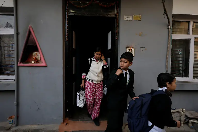 Parbati-Subedi-left-28-wife-of-Dev-Kumar-Subedi-29-who-was-shot-dead-during-youth-led-protests-that-toppled-Nepal-s-prime-minister-and-prompted-elections-set-for-March-5-2026-accompanies-her-daughter-Saloni-Subedi-right-and-her-nephew-Ridam-Panday-to-their-school-before-heading-to-work-in-Lalitpur-Nepal-February-23-2026-Subedi-has-received-the-1-5-million-rupees-compensation-that-an-interim-government-has-provided-to-the-families-of-42-of-the-77-killed-that-it-declared-martyrs-I-believe-this-protest-happened-because-people-wanted-change-in-Nepal-and-change-in-our-leaders-Subedi-said-Those-in-power-forgot-about-families-like-ours-for-whom-putting-two-meals-on-the-table-is-a-daily-struggle-REUTERS-Navesh-Chitrakar-SEARCH-CHITRAKAR-NEPAL-PROTESTER-FAMILIES-FOR-THIS-STORY-SEARCH-WIDER-IMAGE-FOR-ALL-STORIES