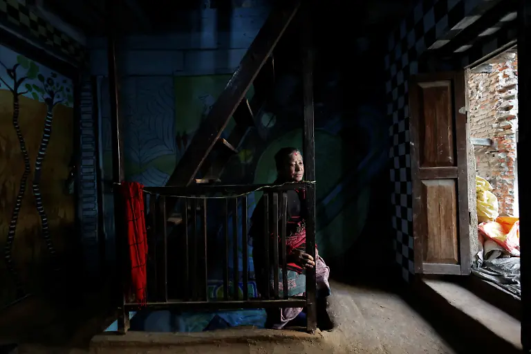 Lata-Maya-Maharjan-75-mother-of-Binod-Maharjan-34-who-was-shot-dead-during-youth-led-protests-that-toppled-Nepal-s-prime-minister-and-prompted-elections-set-for-March-5-2026-climbs-the-stairs-next-to-paintings-made-by-Binod-that-cover-the-wall-of-her-house-in-Lalitpur-Nepal-February-21-2026-After-feeding-pigeons-on-the-terrace-like-he-did-most-mornings-Binod-abruptly-left-home-on-September-8-leaving-his-breakfast-of-rice-and-lentils-The-family-only-discovered-he-had-joined-the-swelling-protests-after-Binod-s-elder-brother-received-a-phone-call-from-one-of-his-sibling-s-childhood-friends-and-rushed-to-Kathmandu-s-Everest-Hospital-My-son-said-he-would-return-home-and-eat-the-meal-he-had-left-behind-said-Lata-Maya-He-never-came-back-REUTERS-Navesh-Chitrakar-SEARCH-CHITRAKAR-NEPAL-PROTESTER-FAMILIES-FOR-THIS-STORY-SEARCH-WIDER-IMAGE-FOR-ALL-STORIES