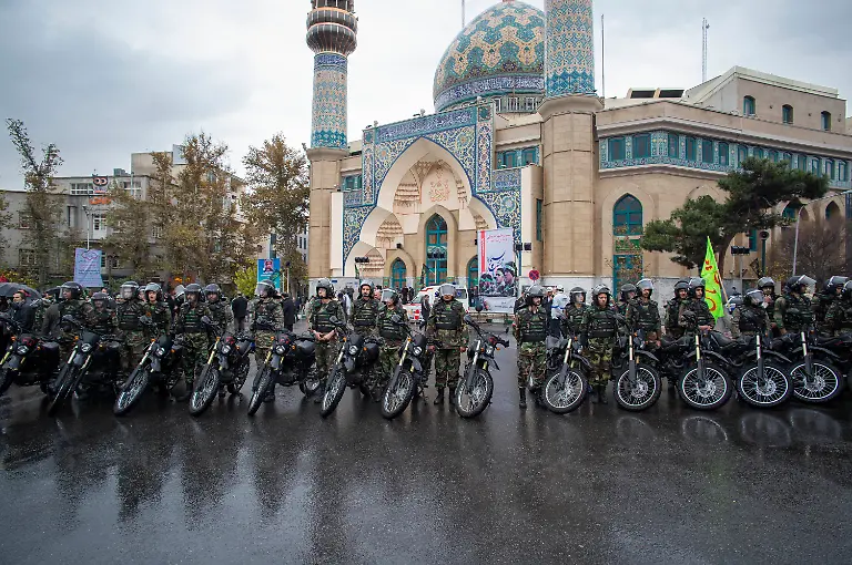 Basij-special-paramilitary-personnel-are-standing-guard-beside-their-motorcycles-during-a-military-rally-in-downtown-Tehran-Iran-on-November-26-2014-The-Basij-officially-known-as-the-Niru-ye-Moqavemat-e-Basij-is-a-volunteer-paramilitary-force-in-Iran-under-the-command-of-the-Islamic-Revolutionary-Guard-Corps-IRGC-It-was-founded-on-April-30-1979-by-Ayatollah-Ruhollah-Khomeini-the-leader-of-the-Islamic-Revolution-to-defend-the-revolution-and-its-values-With-more-than-20-million-members-the-Basij-is-one-of-the-largest-volunteer-militias-in-the-world