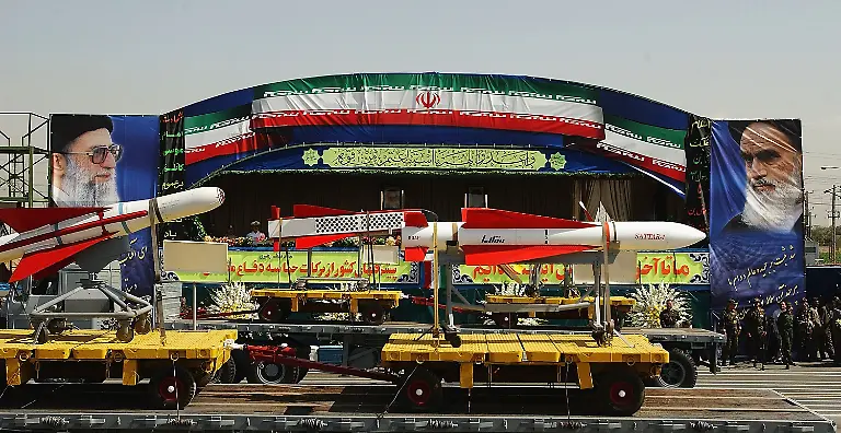 TEHRAN-IRAN-SEPTEMBER-22-Iranian-military-forces-launch-Sacred-Defense-Week-with-a-show-of-force-south-of-Tehran-on-September-22-2003-in-Tehran-Iran-President-Mohammad-Khatami-and-Iranian-military-leaders-reviewed-thousands-of-regular-troops-basiji-militia-and-black-clad-riot-police-as-well-as-tanks-artillery-rockets-and-the-Shahab-3-ballistic-missile-Washington-considers-Iran-part-of-its-axis-of-evil-and-accuses-Tehran-of-harbouring-Al-Qaeda-chiefs-and-of-aiming-for-a-nuclear-arsenal