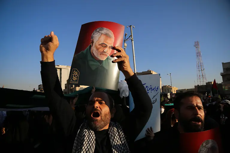 November-18-2023-Tehran-Iran-An-Iranian-man-chants-slogans-as-he-holds-a-poster-of-former-Iranian-major-general-Qasem-Soleimani-who-was-killed-in-a-US-drone-strike-in-Baghdad-on-January-3-2020-during-an-anti-Israeli-rally-to-show-their-solidarity-with-the-people-of-Gaza-at-Enqelab-e-Eslami-Islamic-Revolution-Square-in-Tehran-Thousands-of-Israelis-and-Palestinians-have-died-since-the-militant-group-Hamas-launched-an-unprecedented-attack-on-Israel-from-the-Gaza-Strip-on-07-October-2023-and-the-Israeli-strikes-on-the-Palestinian-enclave-that-followed-it