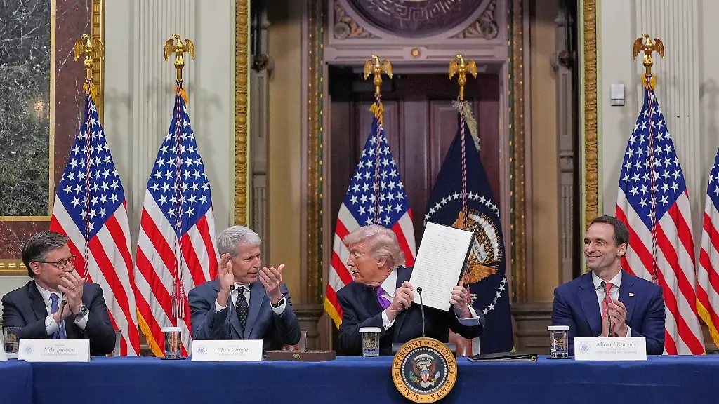 President-Donald-Trump-holds-up-the-Ratepayer-Protection-Pledge-after-signing-it-in-the-Indian-Treaty-Room-of-the-Eisenhower-Executive-Office-Building-on-the-White-House-complex-Wednesday-March-4-2026-in-Washington