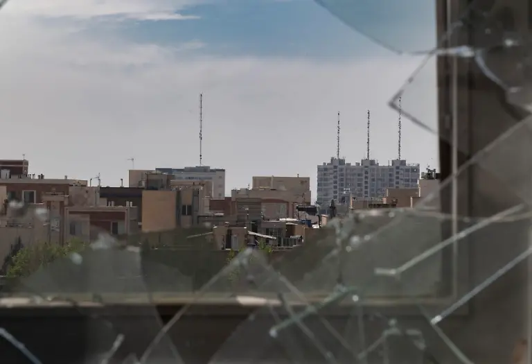 A-view-of-Tehran-through-the-broken-window-of-a-building-that-is-damaged-during-an-attack-on-a-nearby-Iranian-diplomatic-police-station-in-the-U-S-Israeli-military-campaign-in-Tehran-Iran-on-March-4-2026
