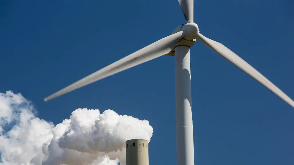 Climate-change-heaven-and-hell-of-a-wind-turbine-with-emissions-from-a-coal-fired-power-station-in-Amsterdam-Netherlands