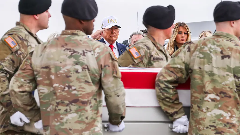 US-President-Donald-Trump-center-salutes-as-members-of-a-US-Army-carry-team-transports-a-flag-draped-transfer-case-containing-the-remains-of-Major-Jeffery-R-O-Brien-during-a-dignified-transfer-at-Dover-Air-Force-Base-in-Dover-Delaware-US-on-Saturday-March-7-2026-President-Donald-Trump-honored-six-US-servicemembers-killed-in-Kuwait-during-the-war-with-Iran-attending-a-solemn-ceremony-as-their-remains-returned-to-home-soil