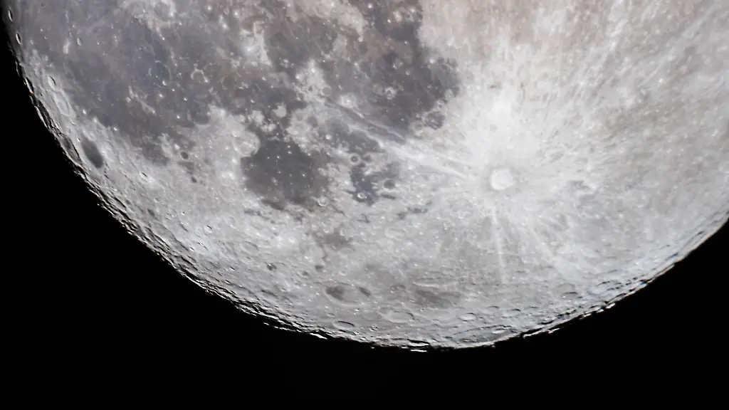 The-13-7-day-old-Moon-a-day-before-Full-with-the-south-polar-region-tipped-toward-us-in-a-favourable-libration-for-viewing-the-southern-regions-and-features-This-was-April-6-2020-The-large-crater-Bailly-is-on-the-southern-limb-better-seen-here-than-at-most-similar-phases-due-to-the-favourable-southern-libration-This-is-a-single-image-with-the-Canon-EOS-Ra-through-the-Celestron-C9-25-inch-Schmidt-Cassegrain-with-a-2X-Barlow-for-a-focal-length-of-5-600mm-Exposure-was-1-100-second-at-ISO-400-The-seeing-was-poor-this-night-The-image-is-processed-for-higher-contrast-and-saturation-to-bring-out-the-tonal-differences-in-the-maria-and-the-rays-from-craters-such-as-Tycho-at-right-of-centre