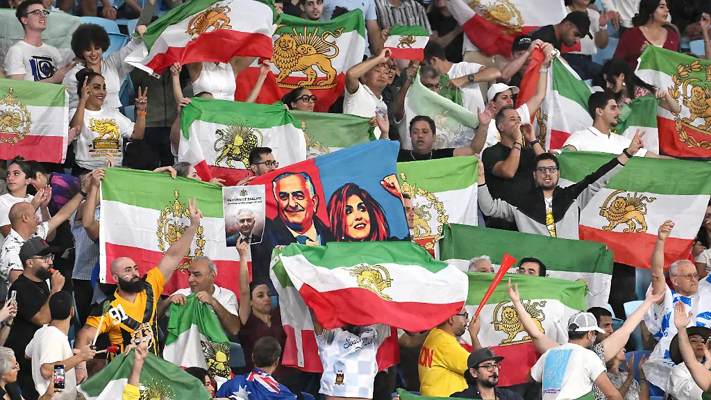 Iran-supporters-wave-flags-and-hold-images-of-Reza-Pahlavi-the-son-of-the-last-Shah-of-Iran-during-the-Women-s-Asian-Cup-soccer-match-between-Iran-and-the-Philippines-in-Robina-Australia-Sunday-March-8-2026