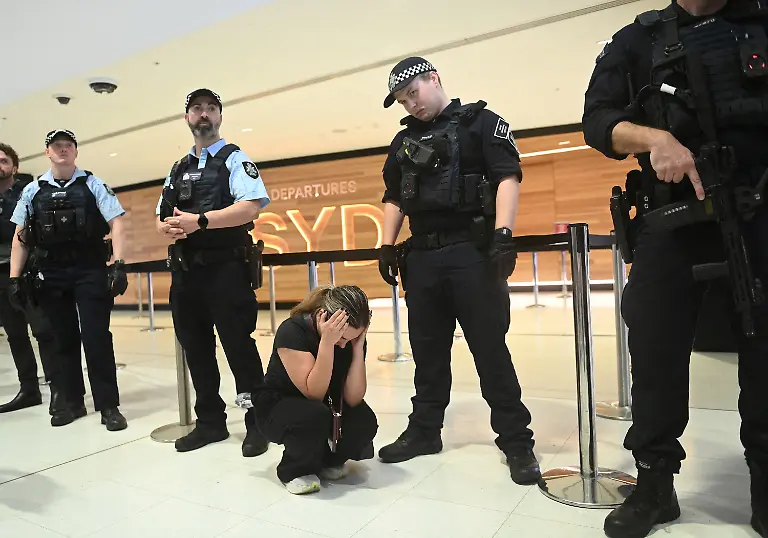 A-woman-reacts-as-supporters-of-the-Iranian-women-s-soccer-team-arrive-at-Sydney-Airport-after-five-of-the-players-were-granted-asylum-in-Sydney-Australia-March-10-2026