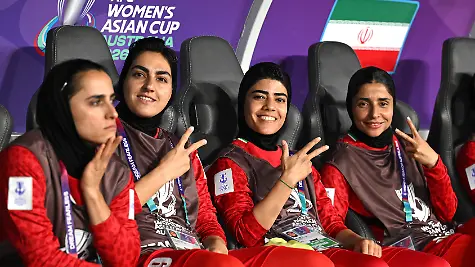 Die-iranische-Mannschaftskapitaenin-Zahra-Ghanbari-2-v-l-Mona-Hamoudi-M-und-Atefeh-Ramazanzadeh-r-reagieren-von-der-Bank-aus-waehrend-des-Spiels-der-Gruppe-A-des-AFC-Frauen-Asien-Pokals-zwischen-dem-Iran-und-den-Philippinen-im-Gold-Coast-Stadium-an-der-Gold-Coast-Sonntag-8-Maerz-2026-Die-Frauen-sind-drei-der-fuenf-iranischen-Fussballspielerinnen-die-in-Australien-Schutz-gesucht-haben-und-denen-humanitaere-Visa-gewaehrt-wurden
