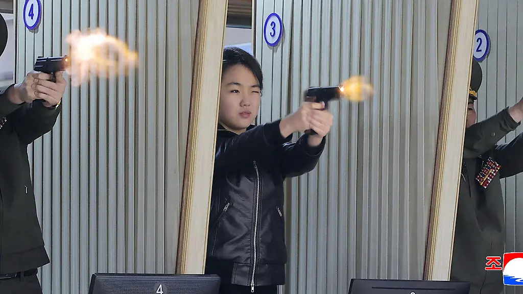 In-this-photo-provided-by-the-North-Korean-government-its-leader-Kim-Jong-Un-s-daughter-center-tries-out-a-new-pistol-at-a-factory-producing-pistols-and-other-light-arms-at-an-undisclosed-place-in-North-Korea-Wednesday-March-11-2026-Independent-journalists-were-not-given-access-to-cover-the-event-depicted-in-this-image-distributed-by-the-North-Korean-government-The-content-of-this-image-is-as-provided-and-cannot-be-independently-verified-Korean-language-watermark-on-image-as-provided-by-source-reads-KCNA-which-is-the-abbreviation-for-Korean-Central-News-Agency