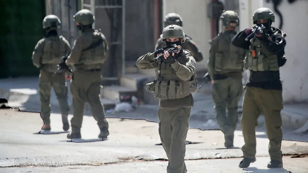 Israeli-soldiers-stand-on-guard-in-the-middle-of-the-market-in-the-Askar-refugee-camp-during-a-military-operation-Israeli-army-forces-raided-the-Askar-refugee-camp-east-of-Nablus-in-the-West-Bank-conducting-a-large-scale-military-operation-searching-homes-and-shops-for-weapons-and-arresting-dozens-of-young-Palestinians