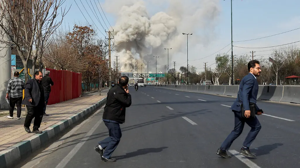People-run-as-smoke-rises-following-an-explosion-amid-the-U-S-Israeli-conflict-with-Iran-in-Tehran-Iran-March-5-2026
