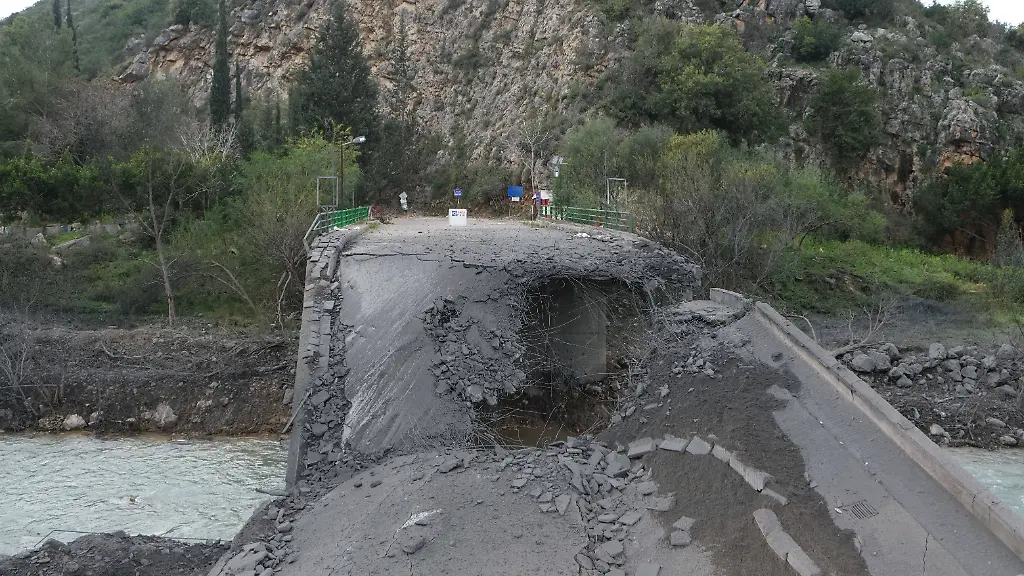 A-view-of-the-scene-shows-the-aftermath-and-destruction-following-an-Israeli-airstrike-on-a-key-bridge-linking-South-Lebanon-to-the-north-located-next-to-a-Lebanese-army-checkpoint-in-Zrarieh-Lebanon-on-March-13-2026