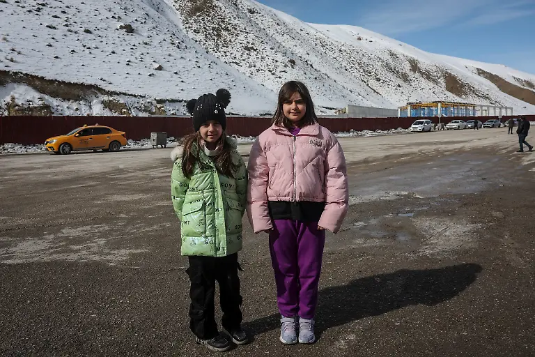 Sisters-Shaylin-Azizour-9-and-Celine-Azizour-11-pose-for-a-portrait-near-the-Kapikoy-border-gate-after-crossing-from-Iran-into-Turkey-in-Van-province-Turkey-March-6-2026-The-sisters-crossed-into-Turkey-with-their-mother-after-travelling-from-Tehran-REUTERS-Dilara-Senkaya-SEARCH-SENKAYA-IRAN-CRISIS-TURKEY-BORDER-FOR-THIS-STORY-SEARCH-WIDER-IMAGE-FOR-ALL-STORIES
