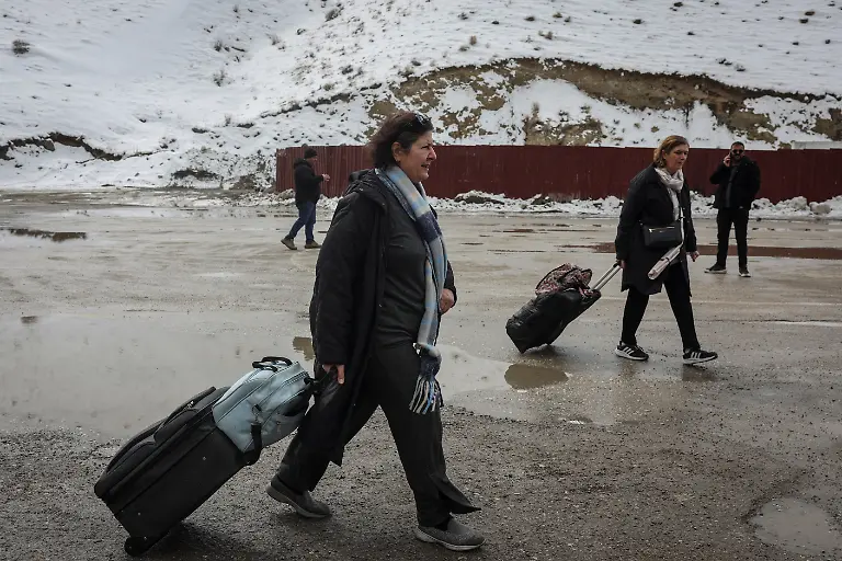 Jalileh-Jabari-63-from-Tehran-Iran-walks-with-a-friend-after-crossing-into-Turkey-in-Van-province-Turkey-March-5-2026-Jabari-said-she-left-Tehran-because-bombs-are-falling-and-the-situation-had-become-unbearable-If-things-become-good-there-if-Iran-becomes-good-I-will-come-back-If-there-is-peace-I-will-return-REUTERS-Dilara-Senkaya-SEARCH-SENKAYA-IRAN-CRISIS-TURKEY-BORDER-FOR-THIS-STORY-SEARCH-WIDER-IMAGE-FOR-ALL-STORIES
