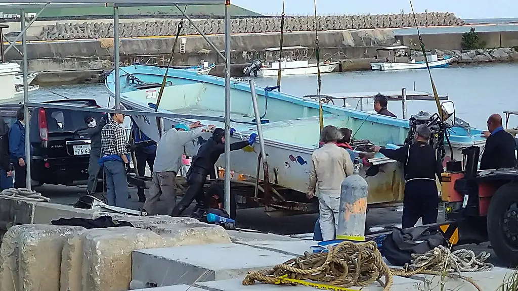 The-boat-Heiwa-Maru-is-seen-after-being-pulled-onto-a-quay-at-Henoko-fishing-port-in-Nago-Okinawa-Prefecture-Japan-Monday-March-16-2026-after-capsizing-off-the-Henoko-district-Two-boats-carrying-high-school-students-on-a-study-trip-capsized-off-Henoko-leaving-two-people-dead-and-two-others-injured