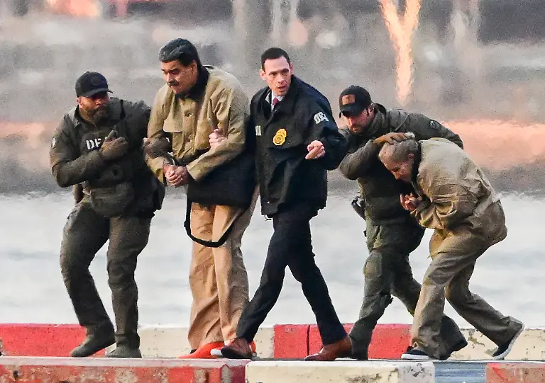 Ousted-President-Nicolas-Maduro-of-Venezuela-and-his-wife-Cilia-Flores-arrive-at-the-Wall-Street-Heliport-in-the-New-York-City-borough-of-Manhattan-NY-to-be-transported-to-appear-in-a-New-York-court-on-Monday-January-5-2026-They-are-to-be-arraigned-as-part-of-a-Narco-Terrorism-indictment-against-them-by-the-United-States-Government