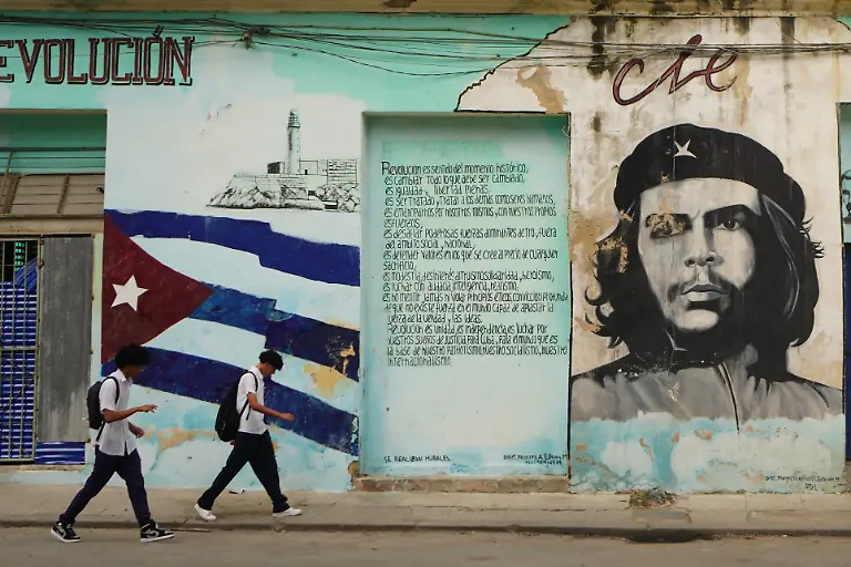260126-HAVANA-Jan-26-2026-Xinhua-Two-young-people-walk-past-a-wall-painted-with-the-portrait-of-Che-Guevara-in-Havana-Cuba-Jan-26-2026
