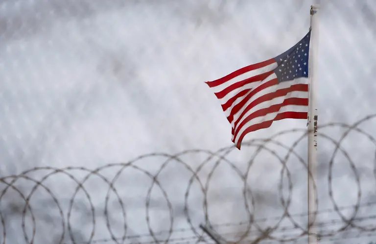 epa01172799-FILE-A-file-picture-dated-12-October-2007-screened-and-cleared-by-the-US-Department-of-Defence-officials-shows-the-US-flag-fly-over-the-detention-facilities-at-US-Naval-Base-Guantanamo-Bay-Cuba-10-October-2007-According-to-media-reports-in-November-2007-US-President-George-W-Bush-considers-to-prepare-the-closing-of-the-prison-and-to-grant-the-detainees-a-larger-amount-of-rights-14-November-2007-The-U-S-Government-currently-maintains-custody-of-approximately-340-enemy-combatants-in-the-Global-War-on-Terrorism-at-Guantanamo-Bay-Cuba-EPA-SHAWN-THEW-THESE-PICTURES-HAVE-BEEN-SCREENED-AND-CLEARED-BY-U-S