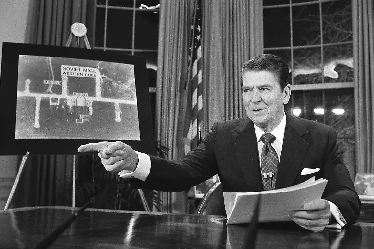 President-Reagan-points-as-he-addresses-the-nation-on-television-March-23-1983-from-Washington-in-support-of-his-proposed-defense-budget-At-left-is-a-picture-of-Soviet-Migs-in-western-Cuba-according-to-the-White-House-The-House-voted-earlier-to-cut-the-defense-budget-in-favor-of-social-programs
