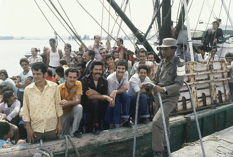 A-Cuban-soldier-stands-by-a-refugee-ship-at-the-small-port-of-Mariel-Cuba-on-April-23-1980-as-the-refugees-aboard-wait-to-sail-for-U-S-where-they-hope-to-start-new-lives-Cuban-President-Fidel-Castro-has-agreed-to-let-the-Cubans-leave-the-communist-island-aboard-boats-that-will-take-them-to-Florida