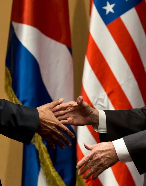 Back-dropped-by-the-US-and-Cuban-flags-US-President-Barack-Obama-left-and-Cuba-s-President-Raul-Castro-shake-hands-after-a-joint-statement-in-Havana-Cuba-Monday-March-21-2016-Brushing-past-differences-President-Obama-and-President-Castro-sat-down-for-a-historic-meeting-offering-critical-clues-about-whether-Obama-s-sharp-U-turn-in-policy-will-be-fully-reciprocated