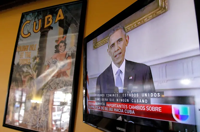 President-Barack-Obama-is-shown-on-a-television-screen-with-Spanish-captions-as-a-Spanish-language-television-network-shows-his-speech-live-inside-a-Cuban-coffee-shop-Wednesday-Dec-17-2014-in-Union-City-N-J-Obama-announced-the-re-establishment-of-diplomatic-relations-and-an-easing-in-economic-and-travel-restrictions-on-Cuba-Wednesday-declaring-an-end-to-America-s-outdated-approach-to-the-communist-island-in-a-historic-shift-aimed-at-ending-a-half-century-of-Cold-War-enmity