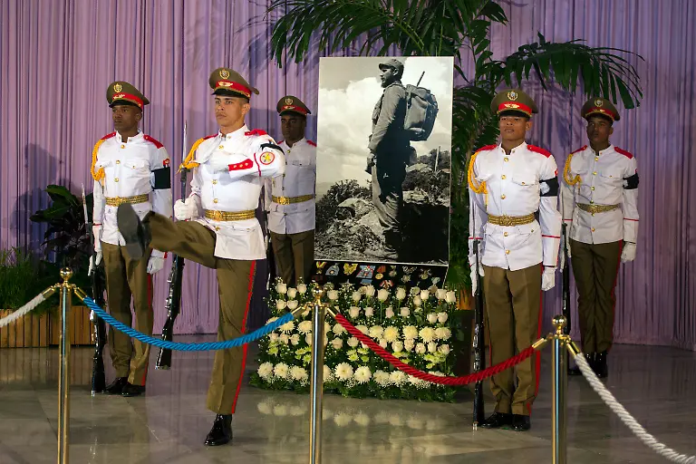 An-honor-guard-flanks-an-image-of-Fidel-Castro-during-a-tribute-to-the-late-leader-at-the-monument-to-independence-hero-Jose-Marti-at-Revolution-Square-in-Havana-Cuba-Monday-Nov-28-2016-The-square-will-be-the-site-of-two-days-of-tributes-to-Castro-Cuba-s-government-has-declared-nine-days-of-national-mourning-following-Castro-s-death-Friday-night-at-age-90
