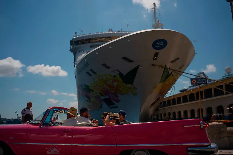 Tourists-who-have-just-disembarked-from-a-cruise-liner-tour-the-city-aboard-a-vintage-American-convertible-in-Havana-Cuba-Tuesday-June-4-2019-The-Trump-administration-has-imposed-major-new-travel-restrictions-on-visits-to-Cuba-by-U-S-citizens-banning-stops-by-cruise-ships-and-ending-a-heavily-used-form-of-educational-travel-as-it-seeks-to-further-isolate-the-communist-government
