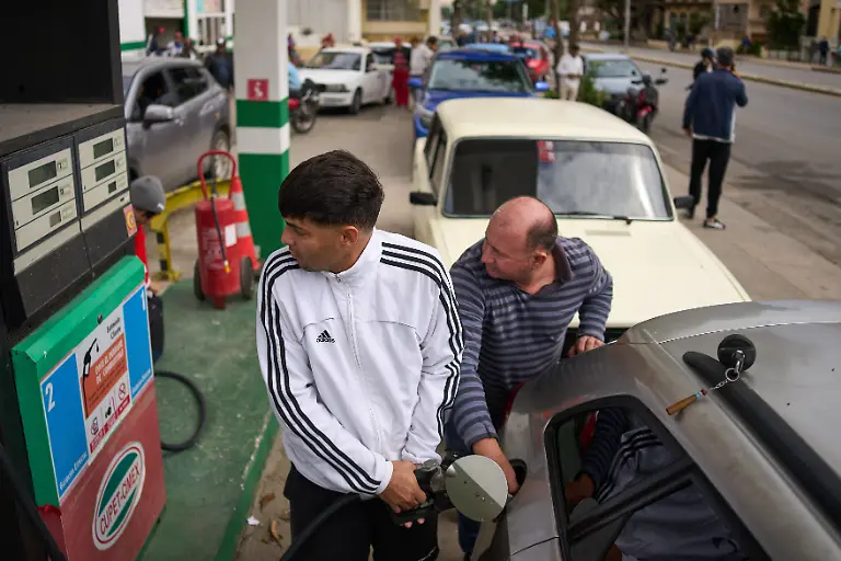 A-driver-refuels-at-a-gas-station-as-others-wait-behind-in-a-long-line-in-Havana-Cuba-Friday-Jan-30-2026