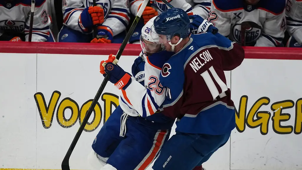 Edmonton-Oilers-center-Leon-Draisaitl-left-is-checked-off-the-puck-by-Colorado-Avalanche-center-Brock-Nelson-in-the-first-period-of-an-NHL-hockey-game-Tuesday-March-10-2026-in-Denver