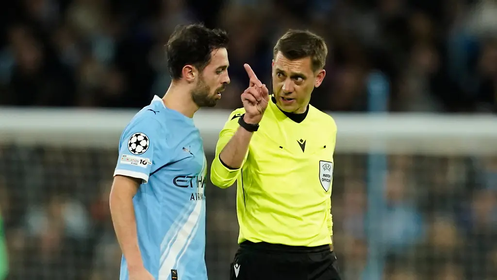 Referee-Clement-Turpin-talks-with-Manchester-City-s-Bernardo-Silva-before-checking-the-VAR-for-a-red-card-during-the-Champions-League-round-of-16-second-leg-soccer-match-between-Manchester-City-and-Real-Madrid-in-Manchester-Tuesday-March-17-2026