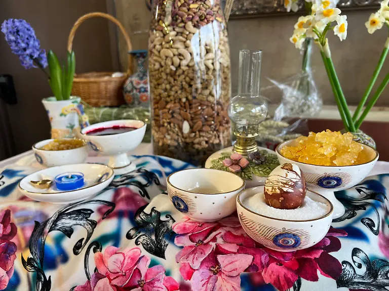 Traditional-items-adorn-a-Haft-Sin-Haft-Seen-an-arrangement-of-seven-symbolic-items-that-all-begin-with-the-letter-S-in-Farsi-during-Nevruz-celebrations-in-Toronto-Canada-on-March-18-2023-Nevruz-Norooz-Nourooz-Newroz-Nowruz-which-means-new-day-marks-the-first-day-of-Spring-and-is-also-celebrated-in-Iran-Afghanistan-Azerbaijan-Albania-Bashkortostan-Bahrain-Georgia-Turkmenistan-Tajikistan-Uzbekistan-Kyrgyzstan-and-Kazakhstan-as-well-as-among-various-other-Iranian-and-Turkic-peoples-in-Iraqi-Kurdistan-Syria-Lebanon-Pakistan-India-northwestern-China-the-Caucasus-the-Crimea-and-the-Balkans-Photo-by-Creative-Touch-Imaging-Ltd