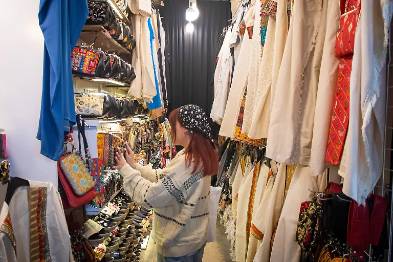 An-Iranian-woman-checks-on-products-in-a-shop-during-the-preparations-for-the-approaching-Persian-New-Year-Nowruz-at-the-Tehran-s-Grand-Bazaar-on-March-17-2024-Nowruz-which-translates-to-new-day-in-Persian-is-a-New-Year-celebration-that-marks-its-beginning-with-the-spring-equinox-and-symbolizes-the-concept-of-rebirth-It-has-been-observed-for-3-000-years-in-different-regions-across-the-Middle-East-Asia-and-Eastern-Europe
