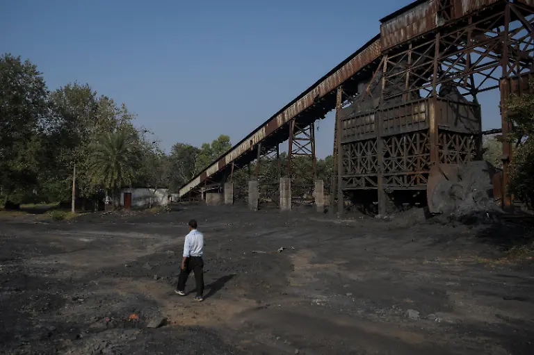 A-South-Eastern-Coalfields-Ltd-SECL-employee-walks-past-a-non-operational-underground-coal-mine-entrance-at-the-Bishrampur-open-cast-mining-area-in-Surajpur-India-November-15-2025-A-40-hectare-solar-park-generating-12-megawatts-of-power-employs-several-local-residents-and-officials-say-they-have-restored-several-hundred-hectares-of-former-mining-land-planting-trees-including-sheesham-a-North-Indian-rosewood-and-mango-SECL-has-spent-around-43-million-rupees-developing-the-project-government-data-shows-REUTERS-Avijit-Ghosh-SEARCH-INDIA-GHOSH-COAL-FOR-THIS-STORY-SEARCH-WIDER-IMAGE-FOR-ALL-STORIES