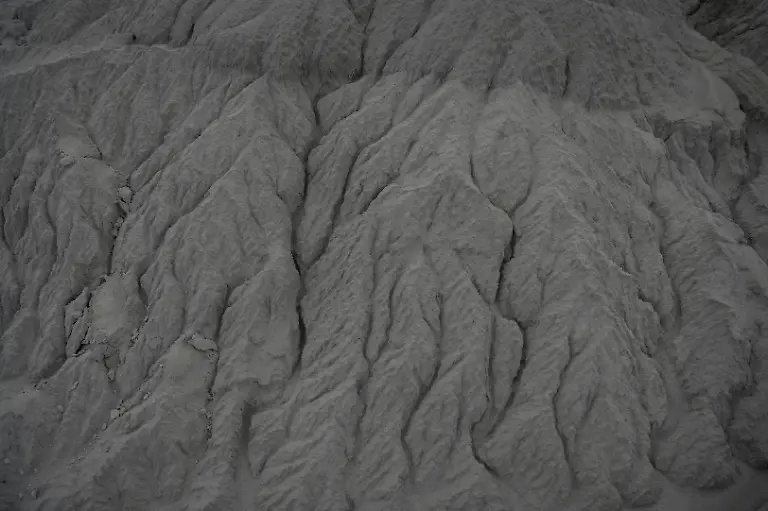 Texture-is-seen-on-a-mixture-of-fly-ash-and-mine-overburden-after-rainfall-at-the-Bishrampur-open-cast-mining-area-in-Surajpur-India-August-11-2025-This-photo-shows-a-moistened-top-layer-at-the-filling-site-after-rainfall-during-monsoon-during-a-later-visit-in-winter-the-required-moisture-was-not-maintained-causing-dust-release-in-violation-of-SOP-Bishrampur-stands-as-a-model-for-India-s-attempts-to-give-its-exhausted-mines-a-second-life-Spread-across-1-472-hectares-5-68-square-miles-the-Bishrampur-mine-s-10-pits-yielded-more-than-38-7-million-tons-of-coal-between-1961-and-2018-when-the-coal-finally-ran-out-REUTERS-Avijit-Ghosh-SEARCH-INDIA-GHOSH-COAL-FOR-THIS-STORY-SEARCH-WIDER-IMAGE-FOR-ALL-STORIES