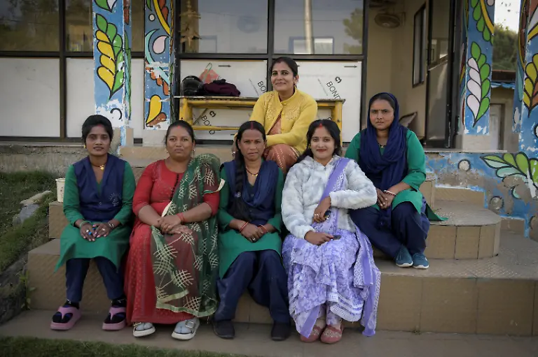 Women-from-the-Shiv-Shakti-Mahila-Gram-Sangathan-self-help-group-pose-for-a-photo-at-Kenapara-Eco-Park-which-was-developed-from-a-closed-open-cast-coal-mine-pit-into-a-small-tourist-hub-in-Surajpur-India-November-16-2025-The-site-which-began-to-be-repurposed-for-tourism-in-2018-is-managed-by-a-women-s-community-group-and-a-fishery-cooperative-and-attracts-as-many-as-150-people-at-the-weekend-and-for-the-women-the-gains-have-gone-beyond-income-Here-women-are-known-by-the-name-of-their-husband-or-father-in-law-We-wanted-to-be-known-by-our-own-names-the-group-s-leader-Pooja-Sahu-said-REUTERS-Avijit-Ghosh-SEARCH-INDIA-GHOSH-COAL-FOR-THIS-STORY-SEARCH-WIDER-IMAGE-FOR-ALL-STORIES