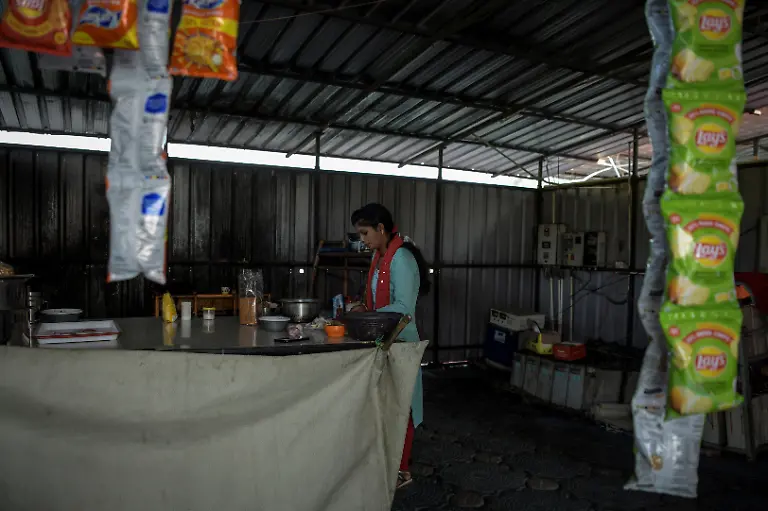 Savita-Gupta-28-prepares-food-for-customers-at-the-floating-restaurant-at-Kenapara-Eco-Park-which-was-developed-from-a-closed-open-cast-coal-mine-pit-into-a-small-tourist-hub-in-Surajpur-India-November-16-2025-The-site-which-began-to-be-repurposed-for-tourism-in-2018-is-managed-by-a-women-s-community-group-and-a-fishery-cooperative-and-attracts-as-many-as-150-people-at-the-weekend-and-for-the-women-the-gains-have-gone-beyond-income-I-hope-my-daughter-will-learn-from-my-life-and-think-about-becoming-an-independent-woman-Gupta-said-REUTERS-Avijit-Ghosh-SEARCH-INDIA-GHOSH-COAL-FOR-THIS-STORY-SEARCH-WIDER-IMAGE-FOR-ALL-STORIES