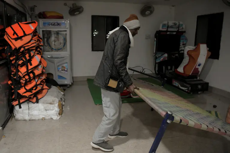 Security-guard-Pannelal-Rajak-78-arranges-a-bed-where-he-rests-during-his-night-shift-at-Kenapara-Eco-Park-which-was-developed-from-a-closed-open-cast-coal-mine-pit-into-a-small-tourist-hub-in-Surajpur-India-November-16-2025-Decades-ago-Rajak-gave-up-his-land-for-the-Bishrampur-open-cast-coal-mine-in-exchange-for-money-and-a-job-in-the-mine-he-believed-would-follow-but-he-never-got-the-job-Today-he-guards-the-same-mine-At-least-I-am-earning-something-here-now-he-says-REUTERS-Avijit-Ghosh-SEARCH-INDIA-GHOSH-COAL-FOR-THIS-STORY-SEARCH-WIDER-IMAGE-FOR-ALL-STORIES